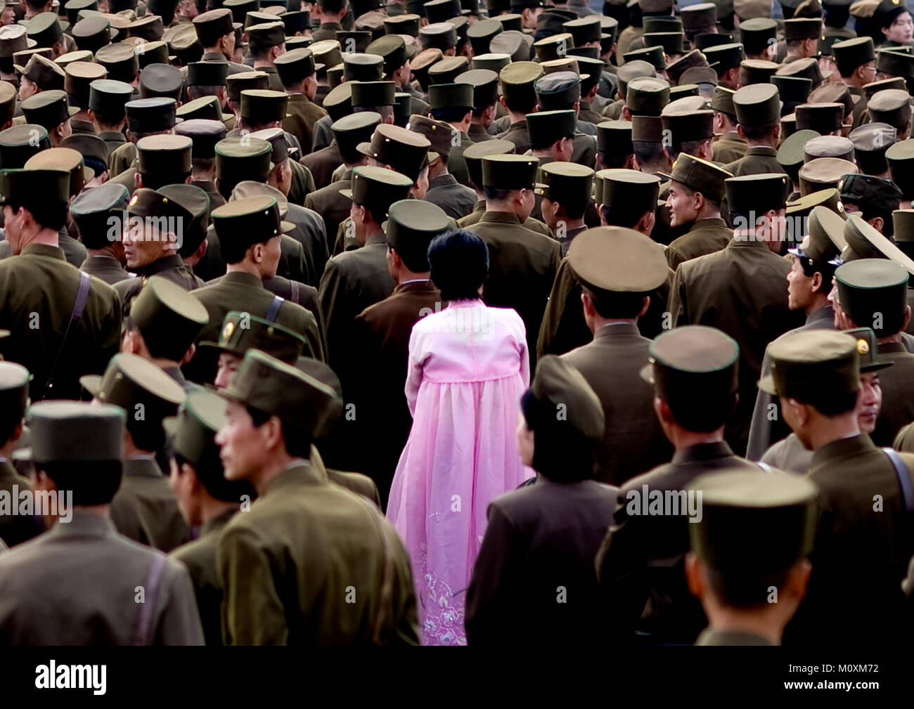 North Korean woman in pink choson-ot in the middle of soldiers, Pyongan Province, Pyongyang, North Korea Stock Photo