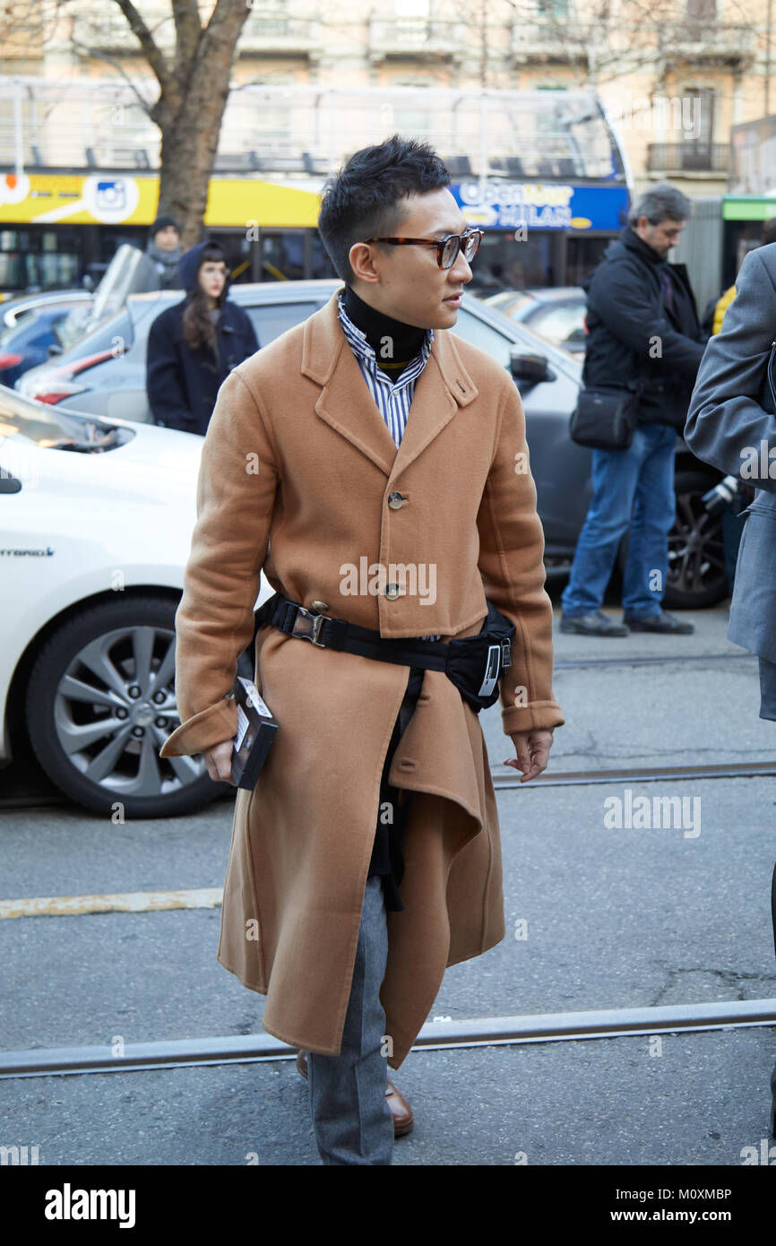 MILAN - JANUARY 13: Man with beige trench coat and black Prada pouch before  Neil Barrett fashion show, Milan Fashion Week street style on January 13  Stock Photo - Alamy