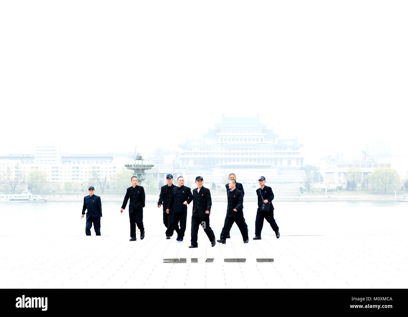 North Korean young men in black suits in Kim il Sung square, Pyongan Province, Pyongyang, North Korea Stock Photo