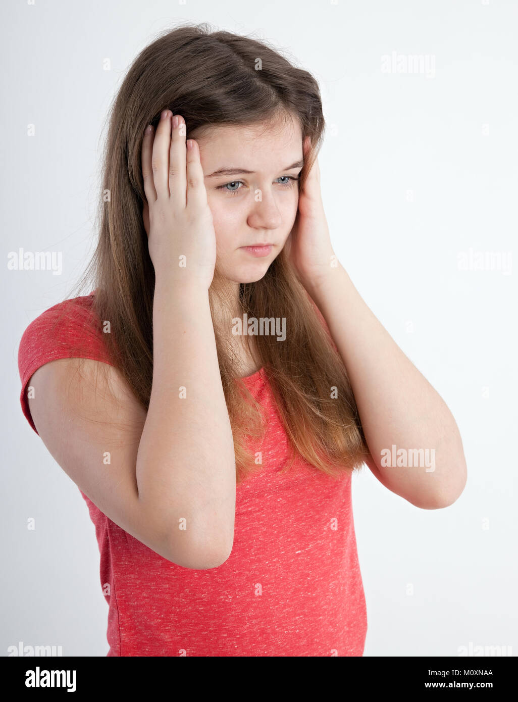 girl closing her ears with hands Stock Photo