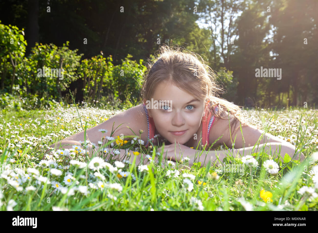 beautiful child lying on green grass Stock Photo