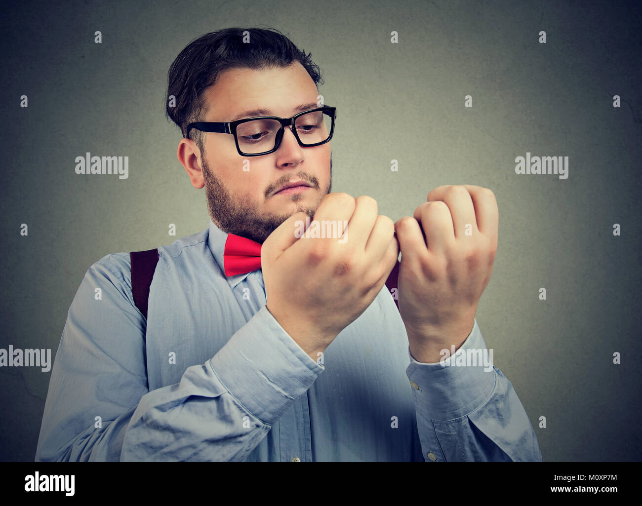 Young serious man with obsessive compulsive disorder exploring cleanliness of hands. Stock Photo