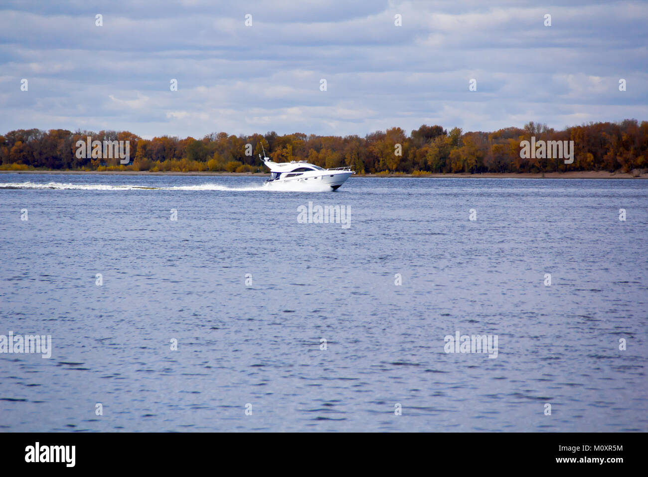 Photo of autumn landscape with motorboat Stock Photo