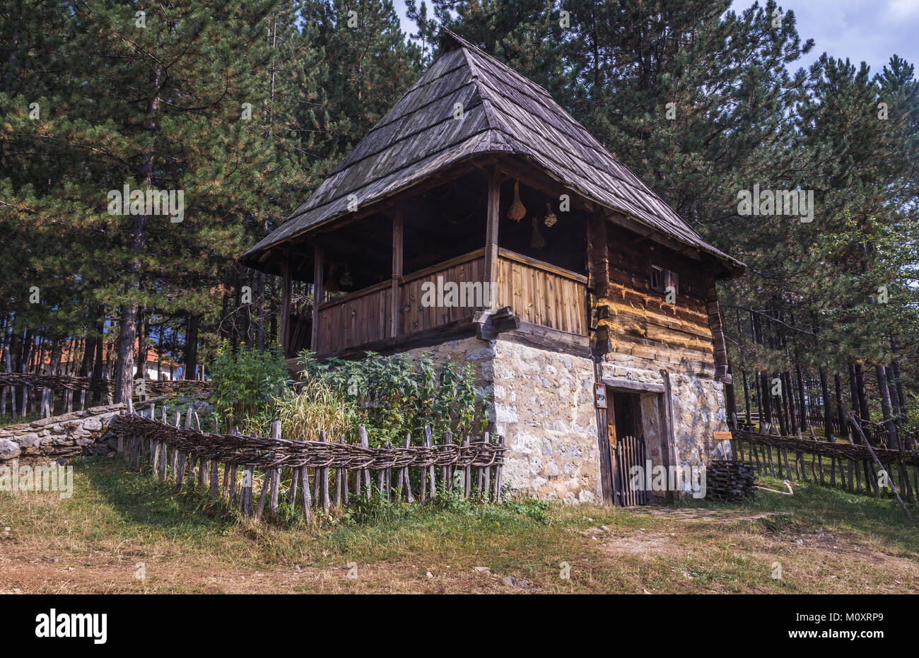 Wooden cottage with porch from 1890 in Ethnographic heritage park called Old Village Museum in Sirogojno village, Zlatibor region, Serbia Stock Photo