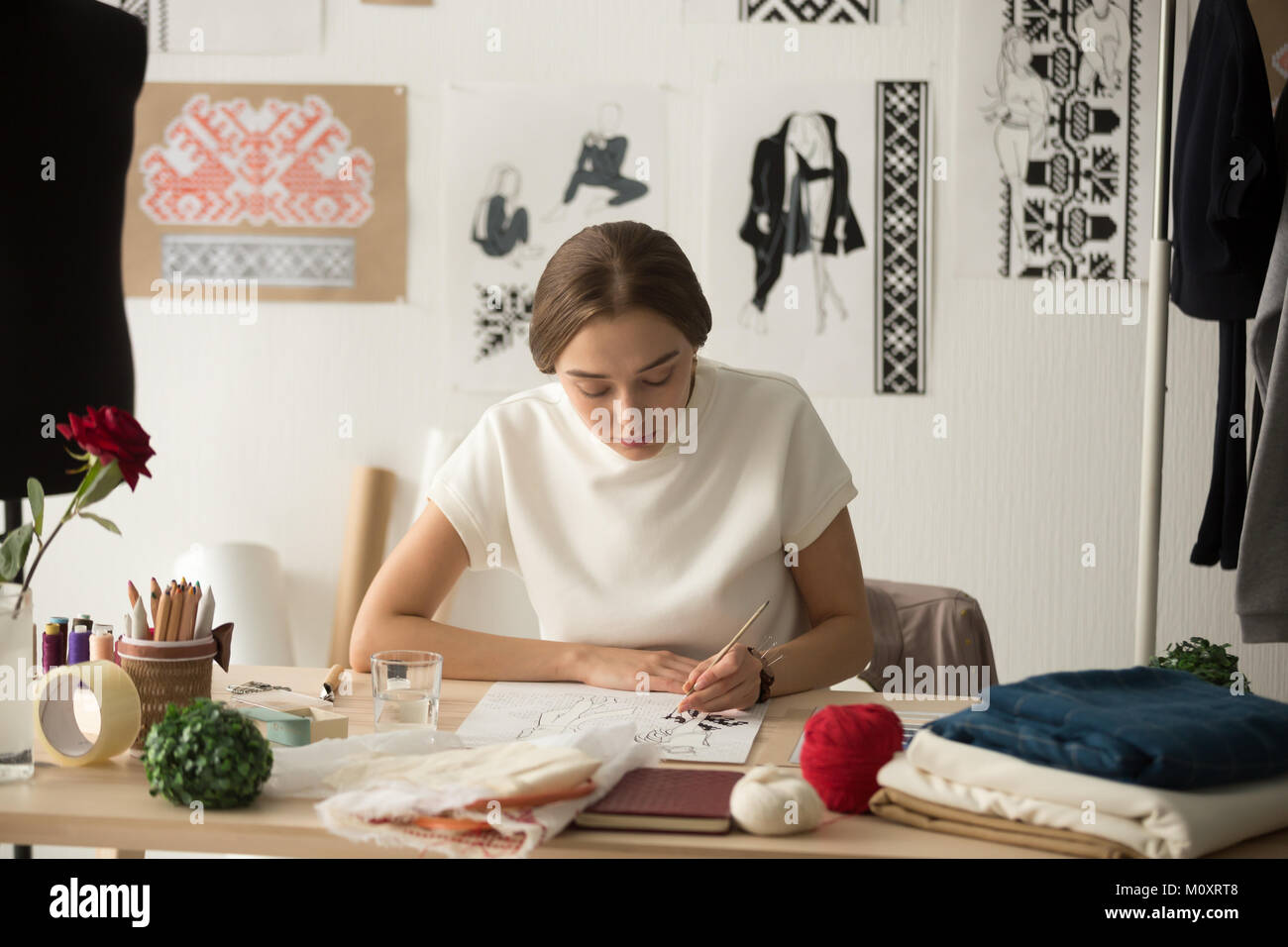 Inspired fashion designer working in studio drawing new collecti Stock ...