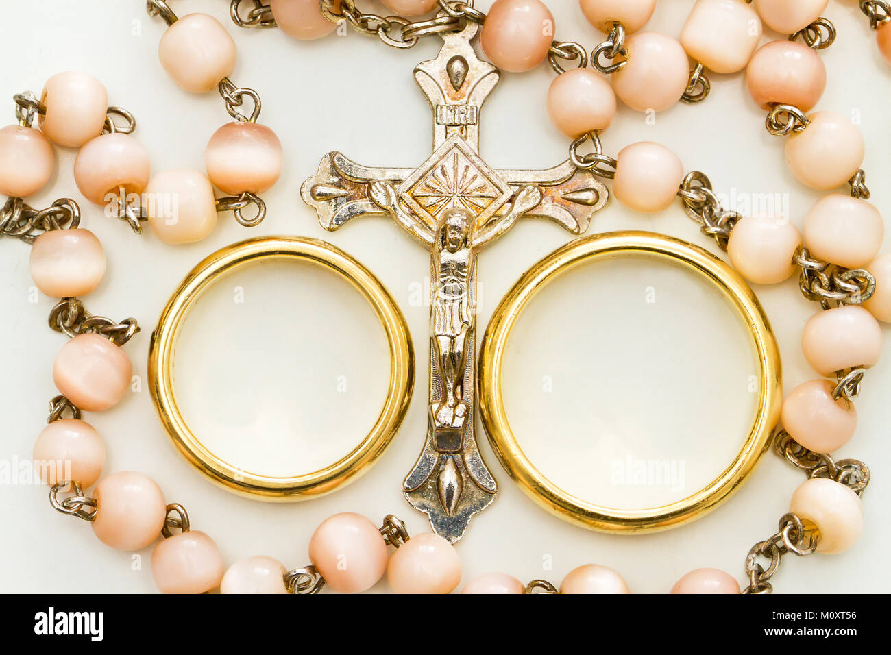 Two wedding rings and necklace with crucifix Stock Photo
