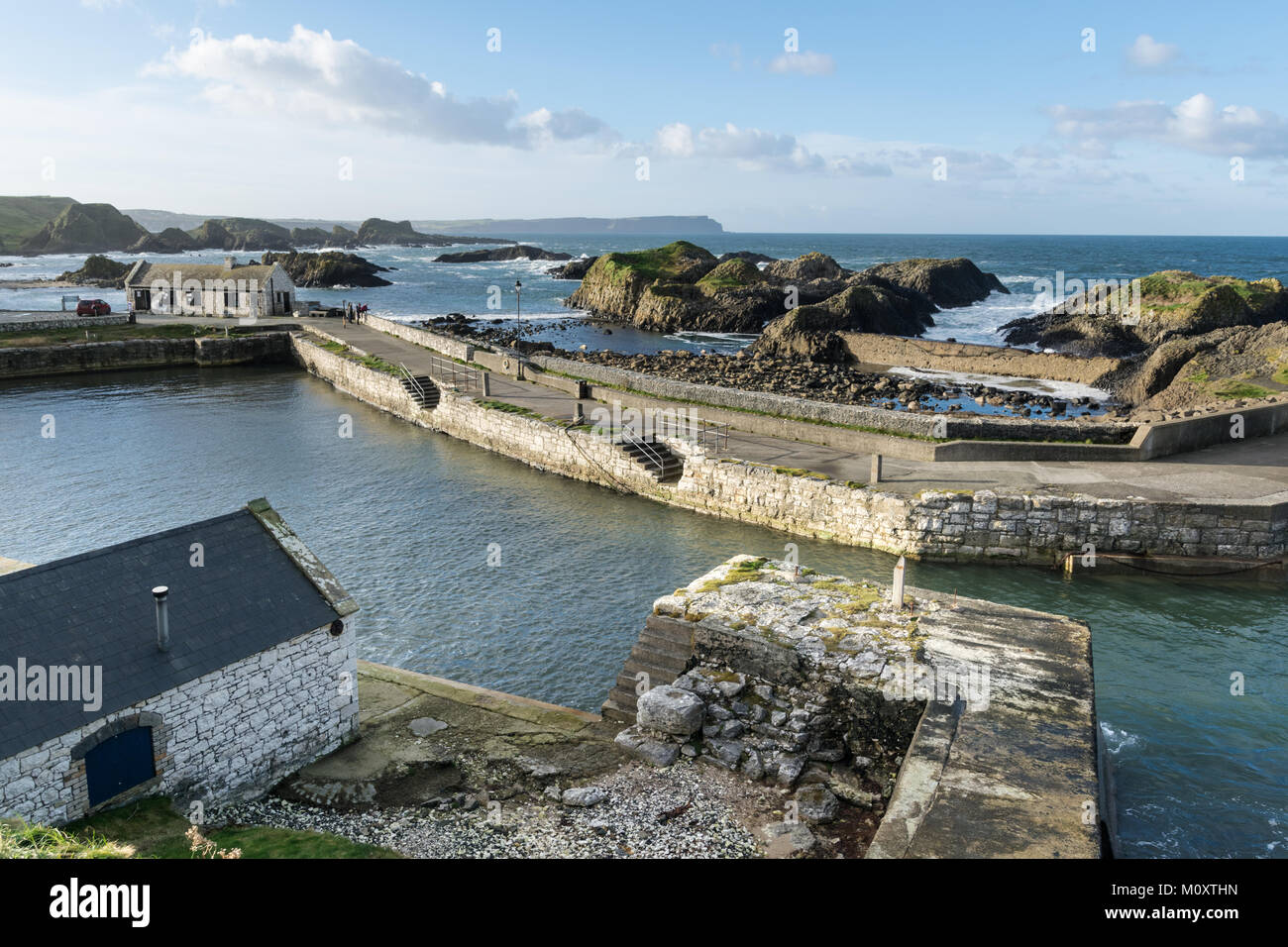 This Ballintoy Harbour which is located on the Antrim Coast in Northern Ireland.  It is an old Fishing boat harbour that has been used as a film set Stock Photo