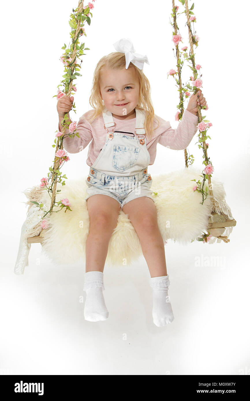 Pretty 3 Year Old Girl Playing On A Swing Stock Photo