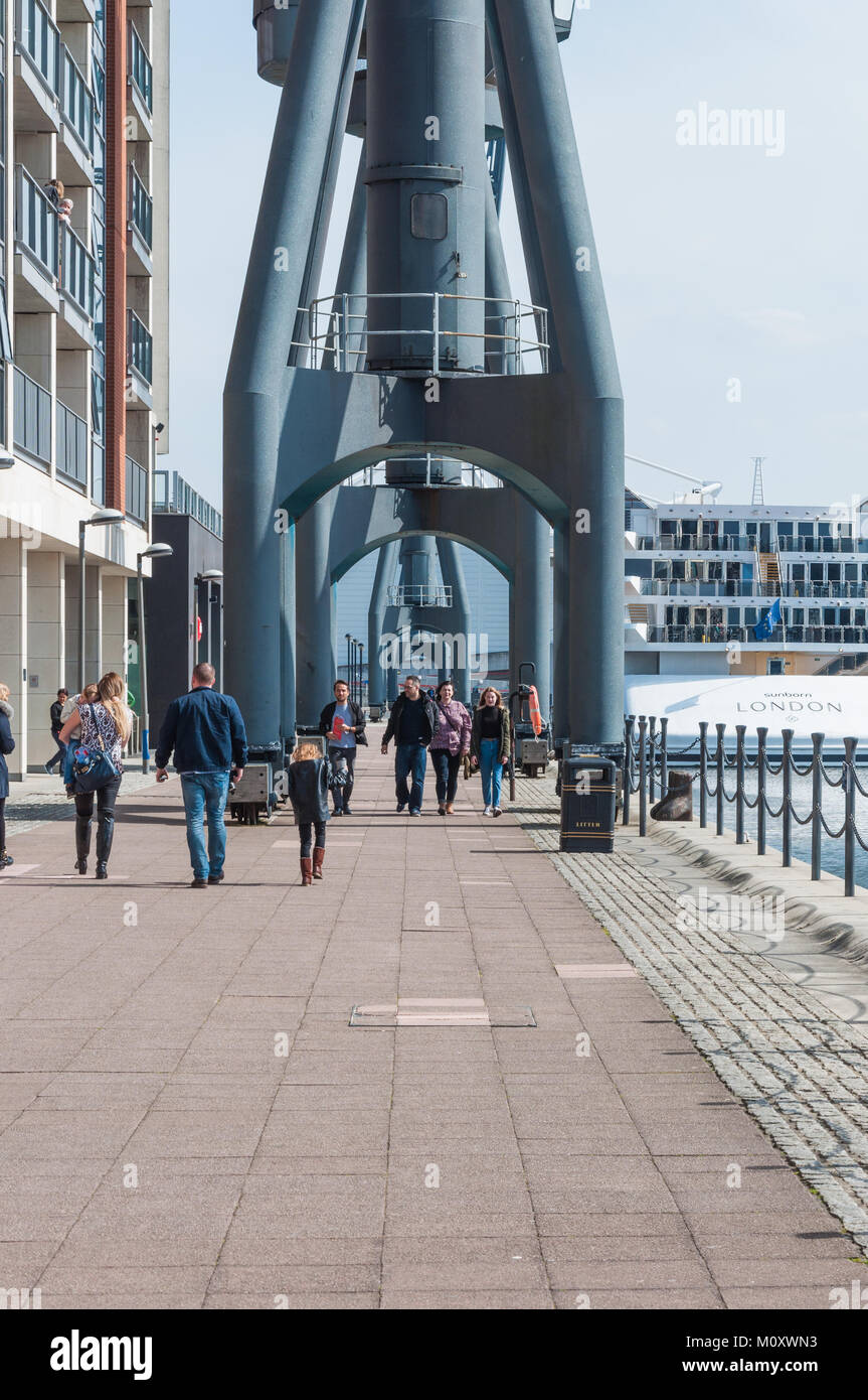People strolling along the quayside at the Royal Victoria Dock, East London. Stock Photo