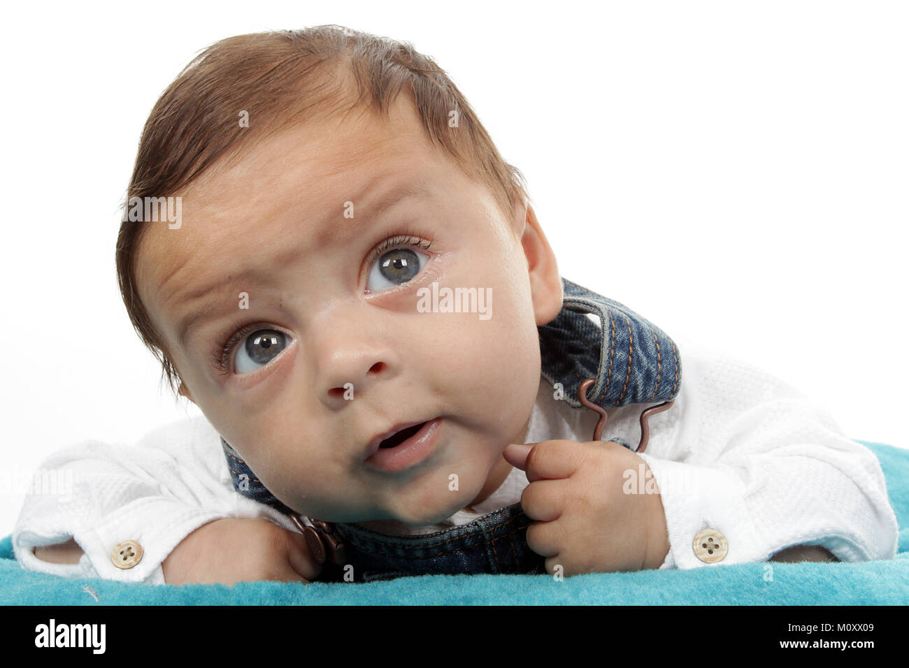 3 month old mixed race baby boy playing on a rug Stock Photo