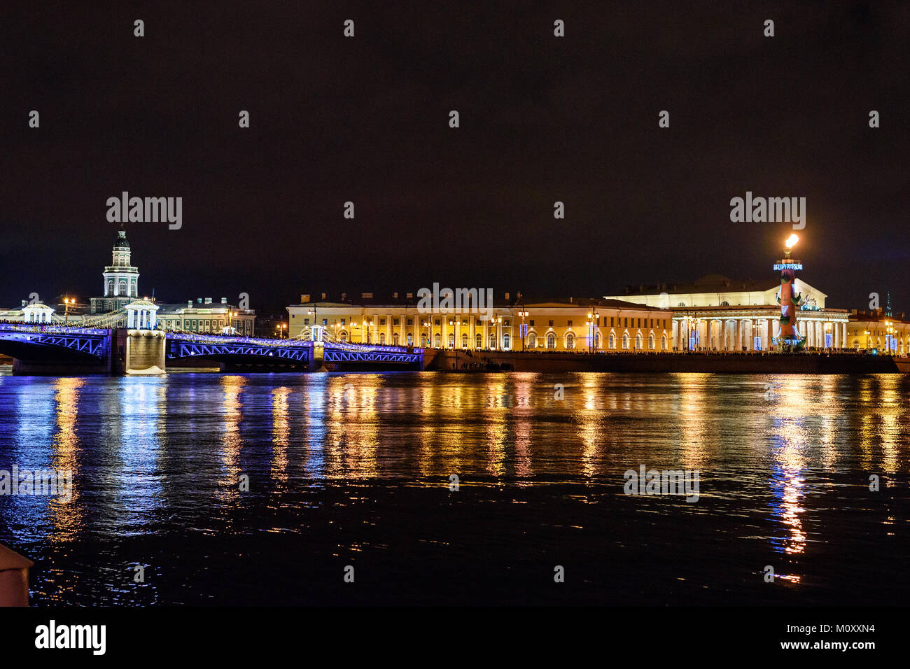 Palace Bridge and Vasilyevsky island Spit Strelka with Rostral columns at night. New Year and Christmas illumunated. Saint Petersburg, Russia Stock Photo