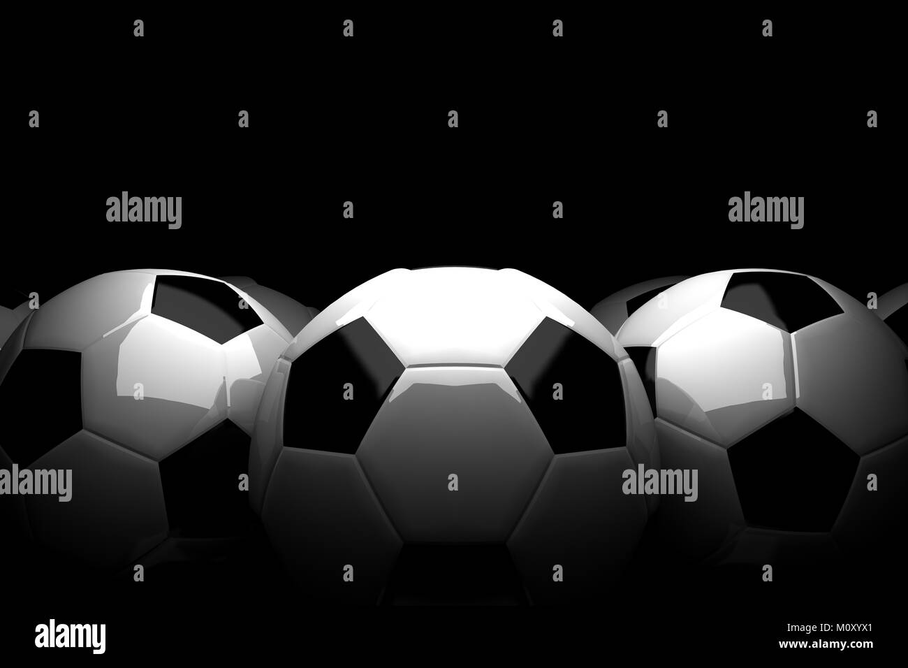 classic soccer balls made of white and black leather. Grouped with dim light on dark background Stock Photo
