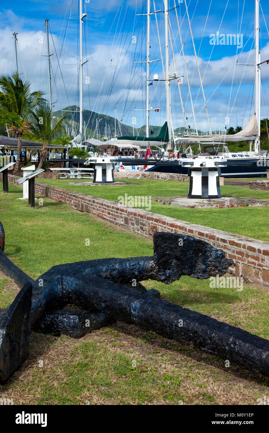 Old rusted anchor and sailboats at Nelson's Dockyard, Antigua, West Indies Stock Photo
