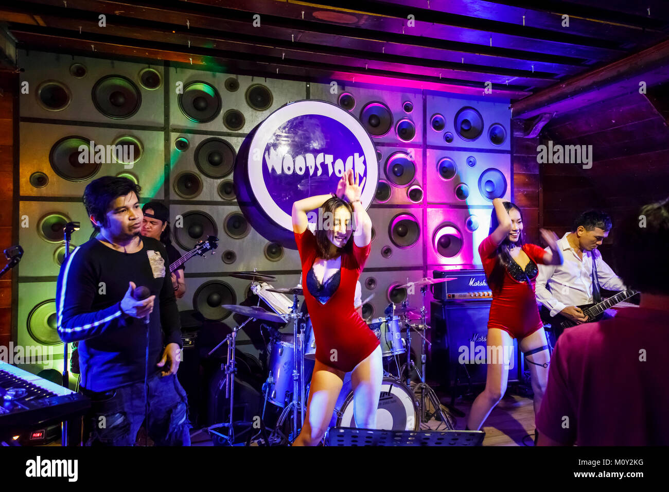 Local live rock band playing and exotic dancers performing on stage at Woodstock, a night club in downtown Saigon (Ho Chi Minh City), south Vietnam Stock Photo