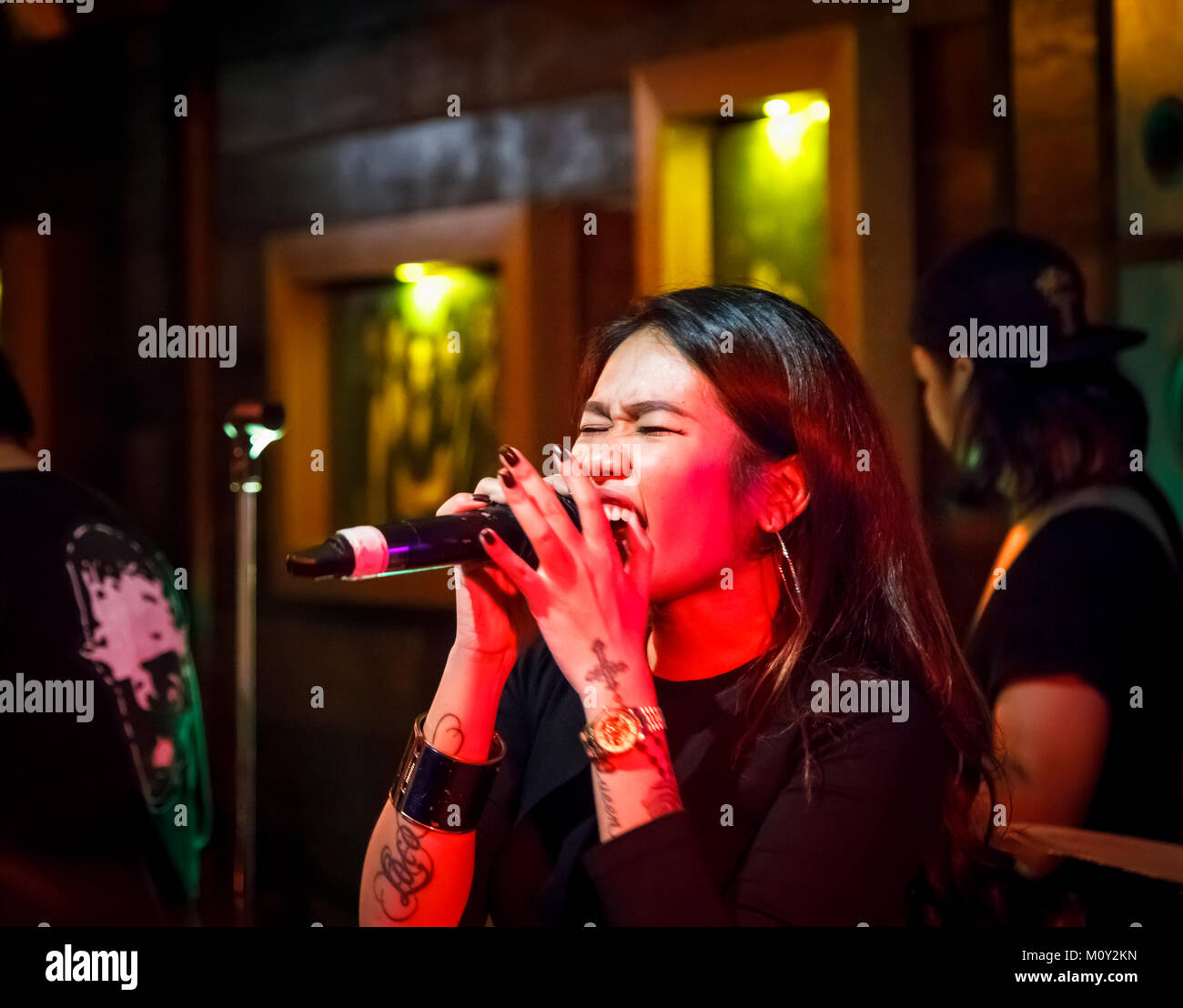 Female lead singer of a local live rock band singing at Woodstock, a night club in downtown Saigon (Ho Chi Minh City), south Vietnam, southeast Asia Stock Photo