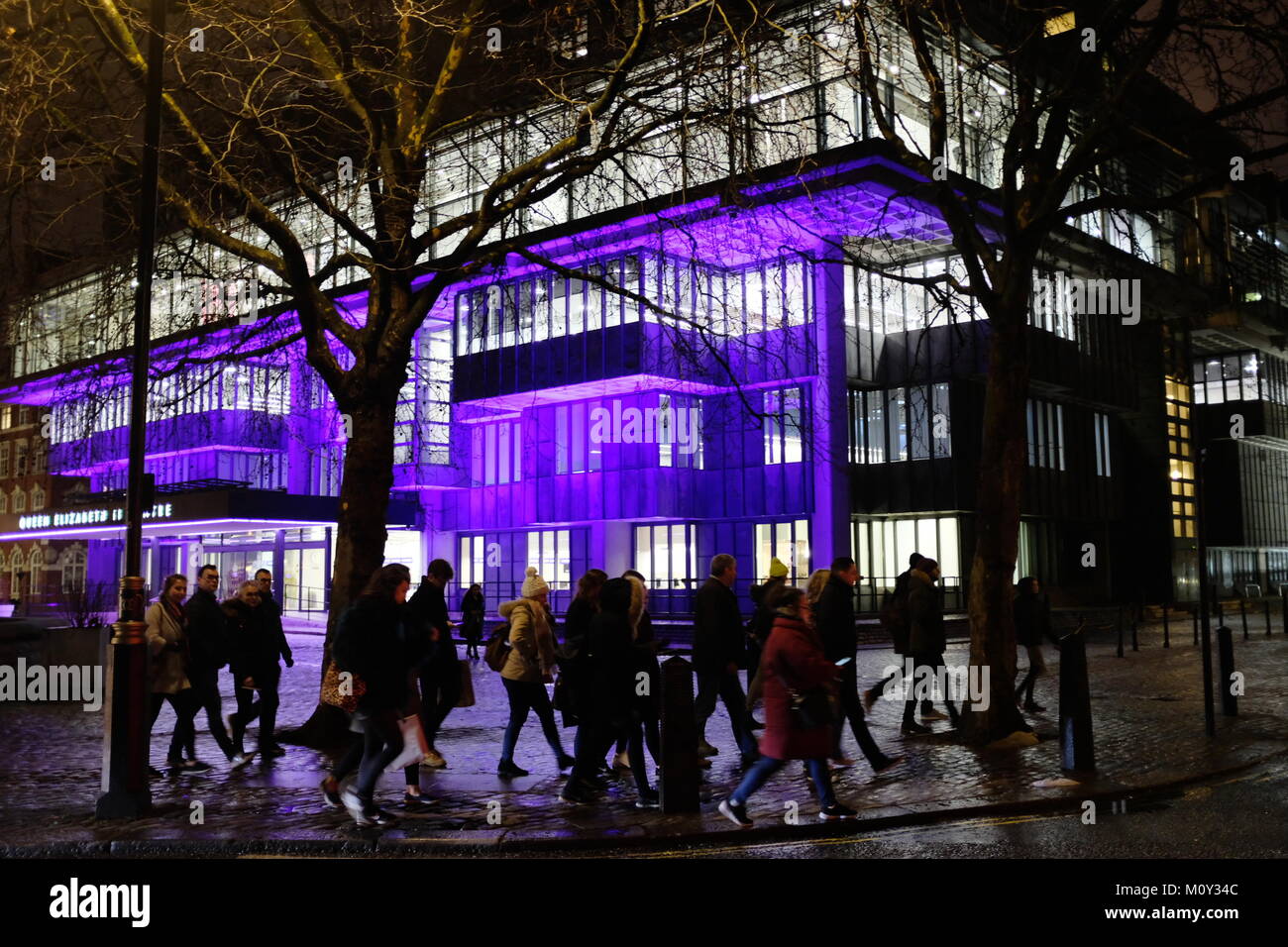 Crowds of people walking by Queen Elizabeth II Centre in London ...
