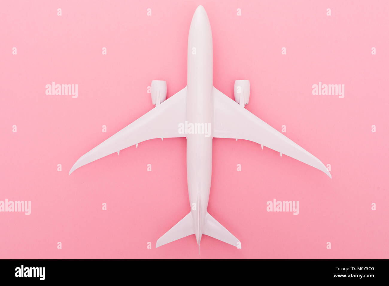 White toy plane on light rose background. Top view Stock Photo - Alamy