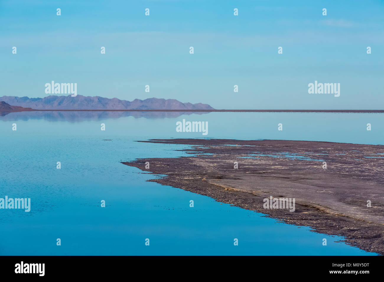 A spit of land with vast shallow flooded salt flats at the Bonneville Salt Flats, which is BLM land west of the Great Salt Lake, Utah, USA Stock Photo