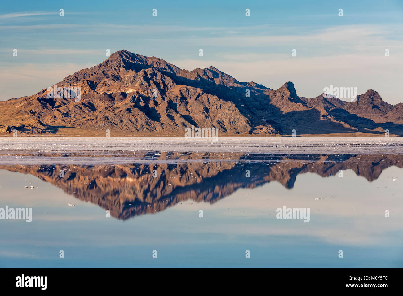 Silver Island Range reflecting in salty water at the Bonneville Salt Flats, which is BLM land west of the Great Salt Lake, Utah, USA Stock Photo