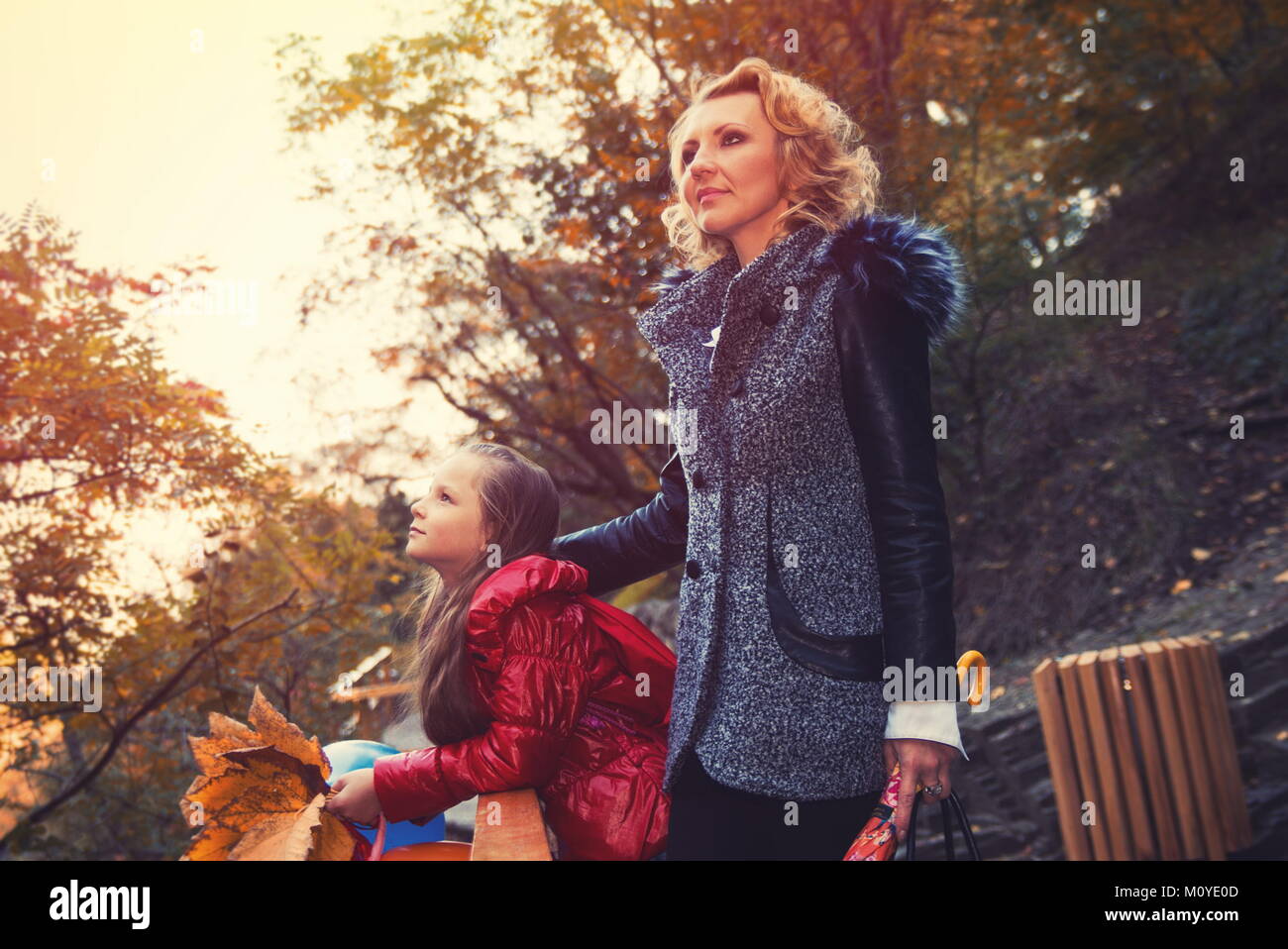 Mother with daughter in the autumn park Stock Photo - Alamy