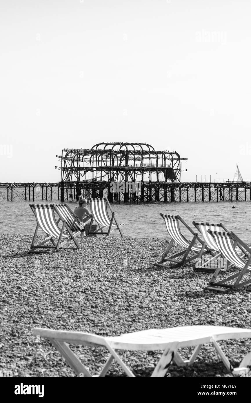 Tourist relaxing on the hired stripy deckchairs Stock Photo