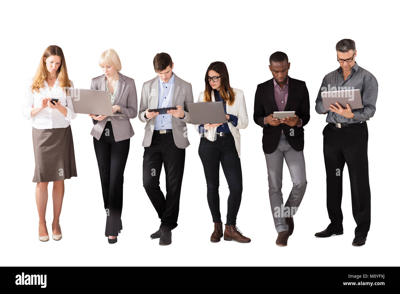 Group Of Multi Ethnic Business People Using Electronic Devices Against White Background Stock Photo