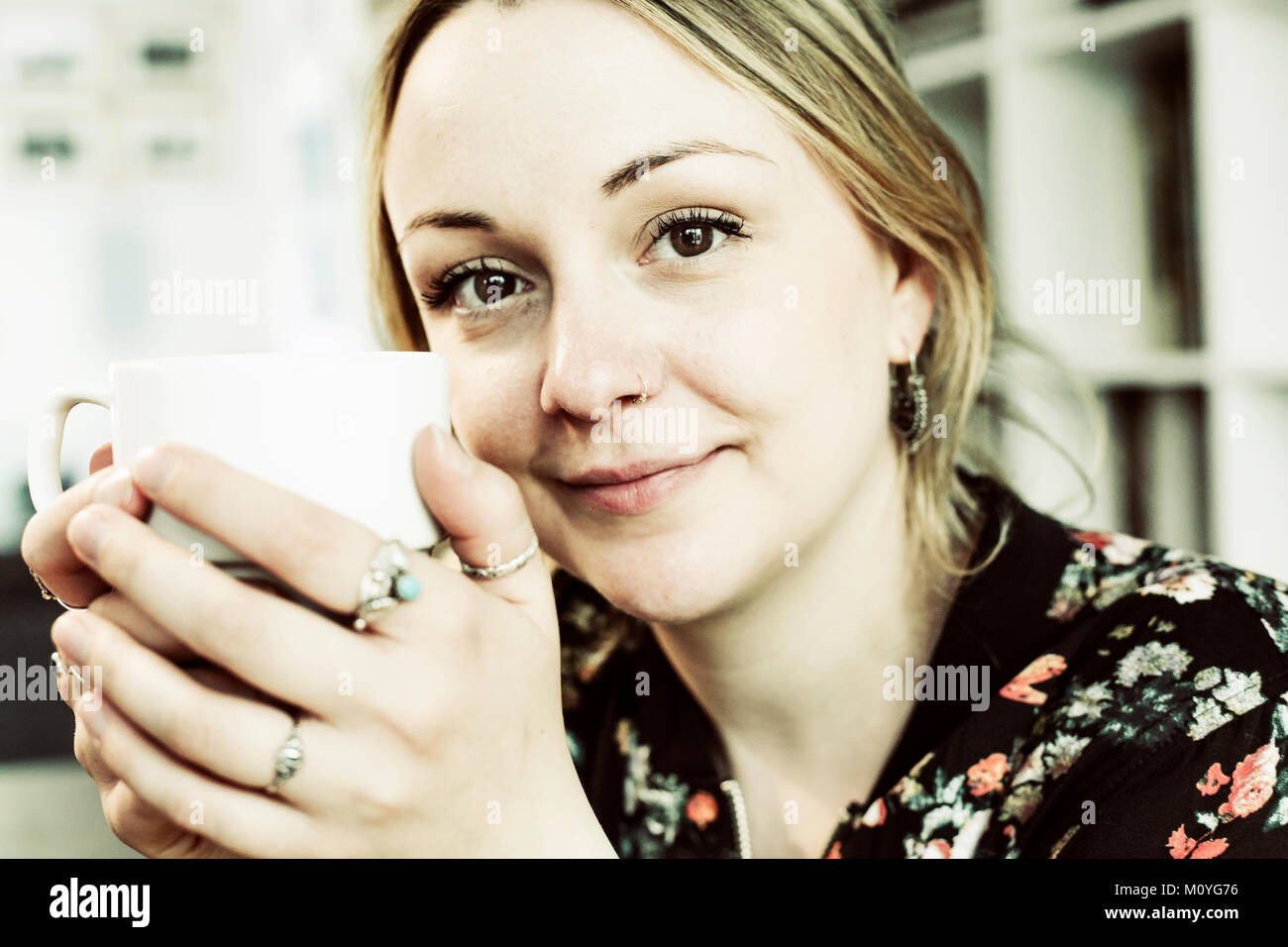 Young woman with a cup of coffee in her hand,portrait,Germany Stock Photo
