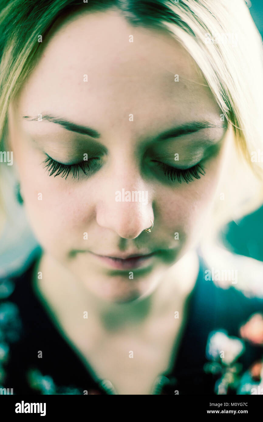 Young woman with closed eyes and nose piercing,portrait,Germany Stock Photo Alamy