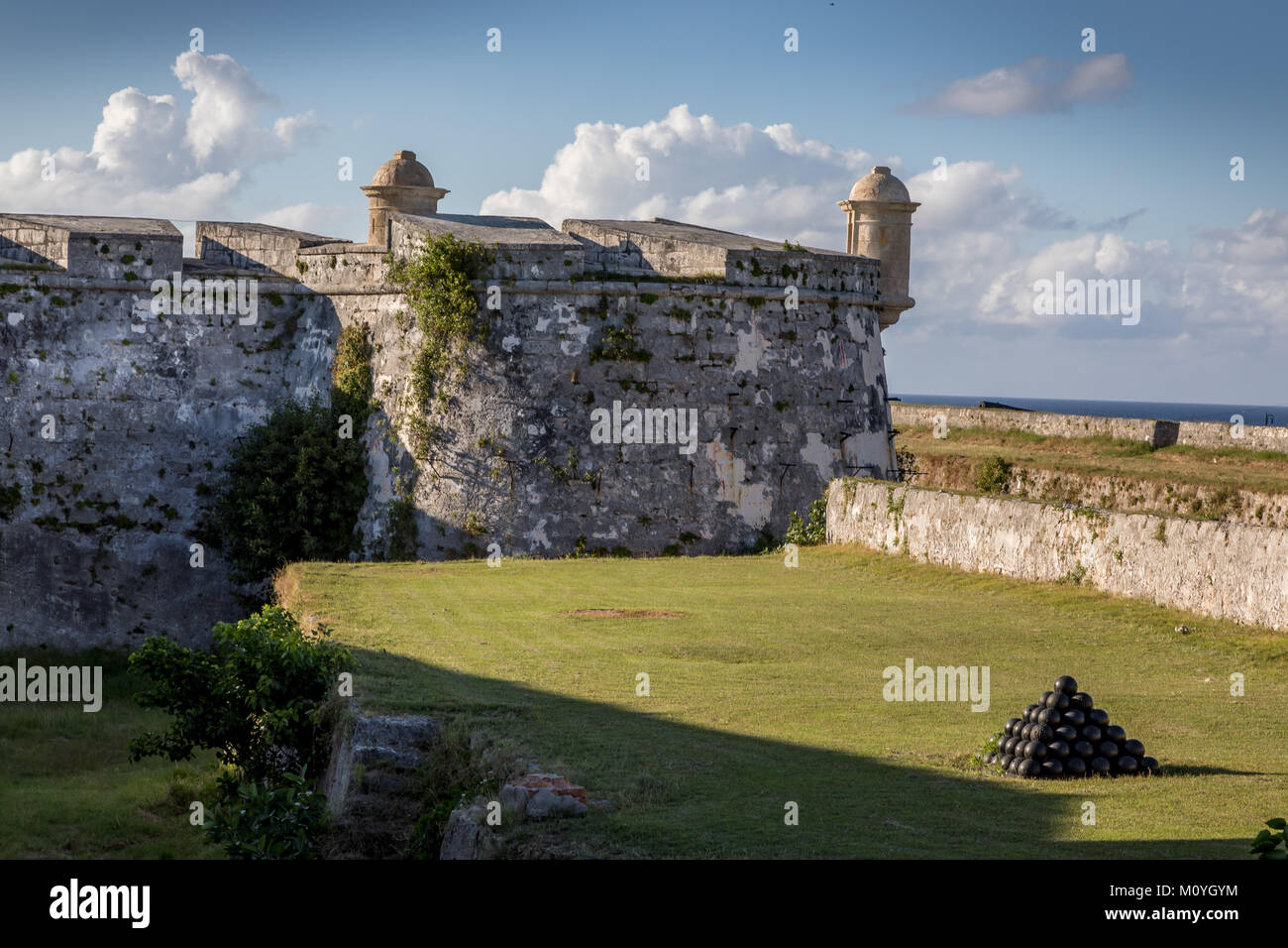 Cuba, Havana. Fortress wall and Cuban flag at San Carlos de