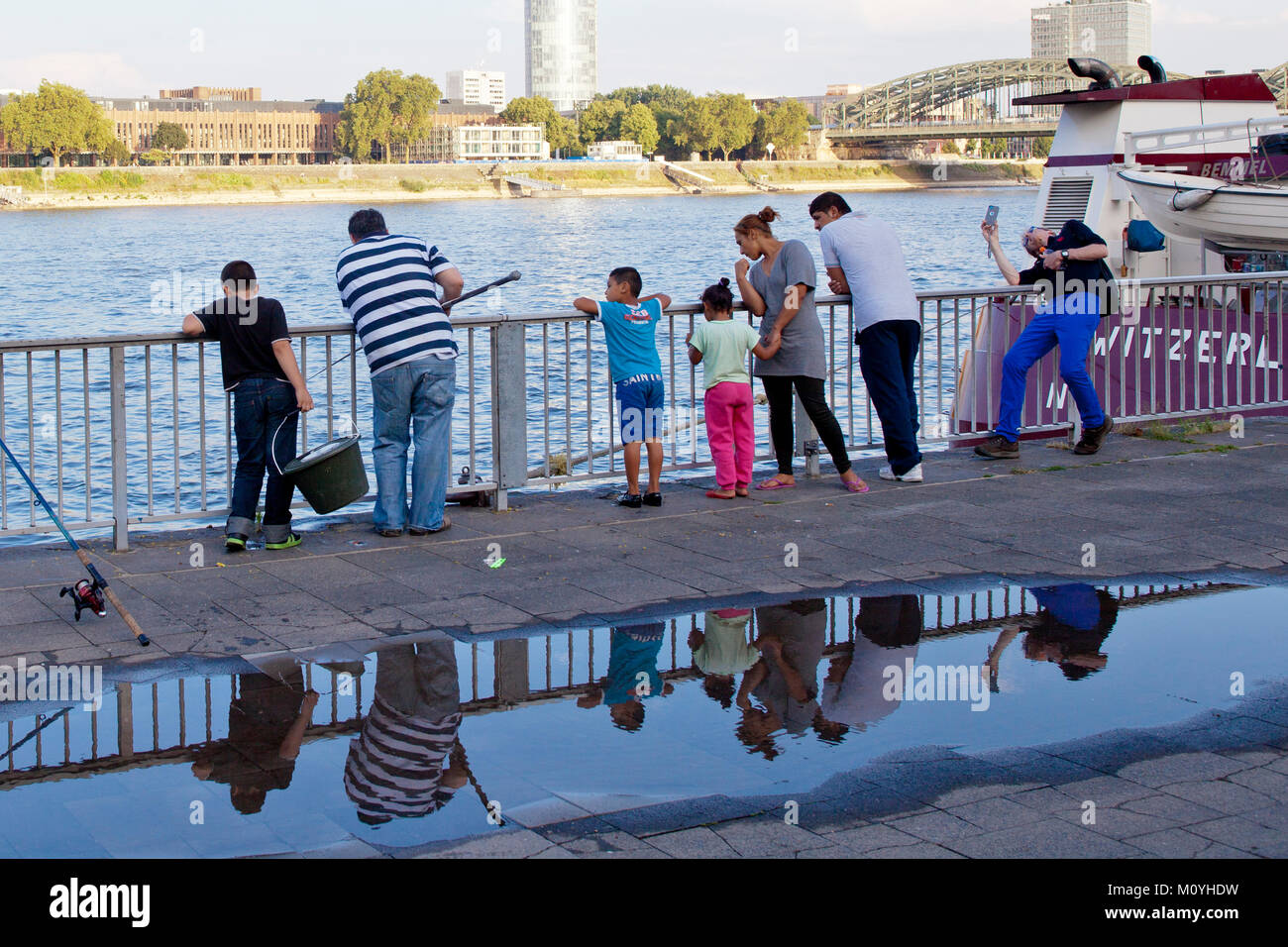 Germany, Cologne, fisherman and bystanders at the river Rhine  Deutschland, Koeln, Angler und Zuschauer am Rheinufer. Stock Photo