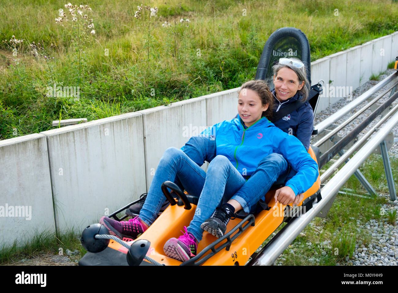 Mother and daughter a with the Alpine Coaster,summer toboggan run at the near Oberammergau Stock Photo -