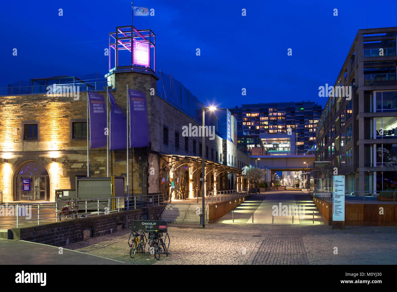 Germany, Cologne, the Rheinau harbour, on the left the German Sport and Olympic Museum, in the background the Crane Houses by architect Hadi Teherani. Stock Photo