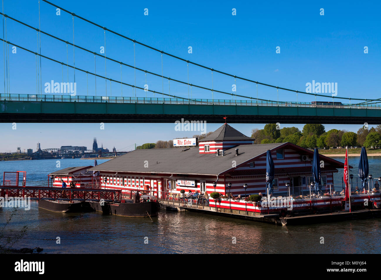 Germany, Cologne, the boathouse restaurant Alte Liebe on the river Rhine near the Rodenkirchener bridge, in the background the cathedral.  Deutschland Stock Photo