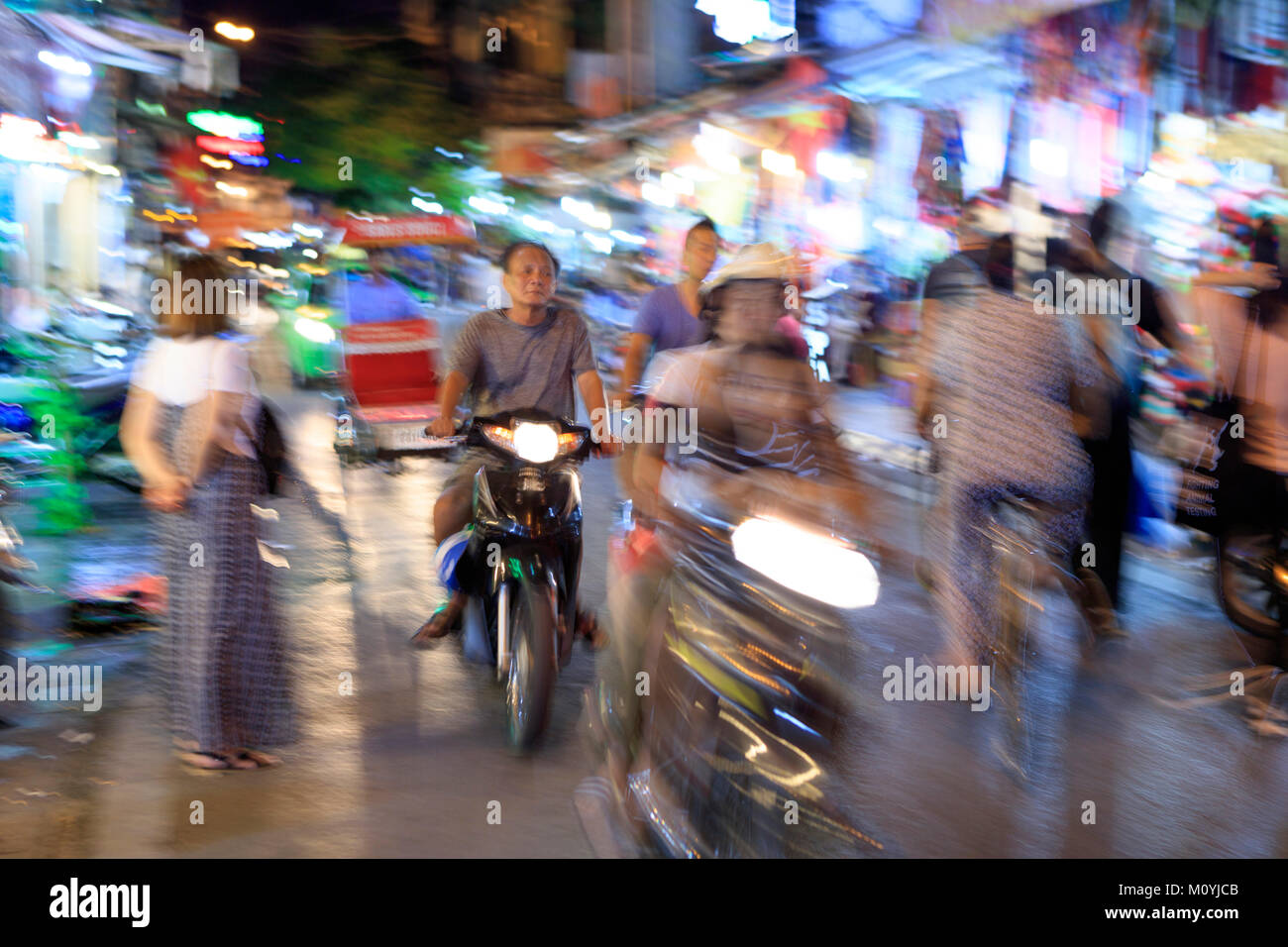 Busy motorbike, bicycle and pedestrian traffic in a street in old Hanoi's Ba Dinh District, Hanoi, Vietnam, Asia Stock Photo