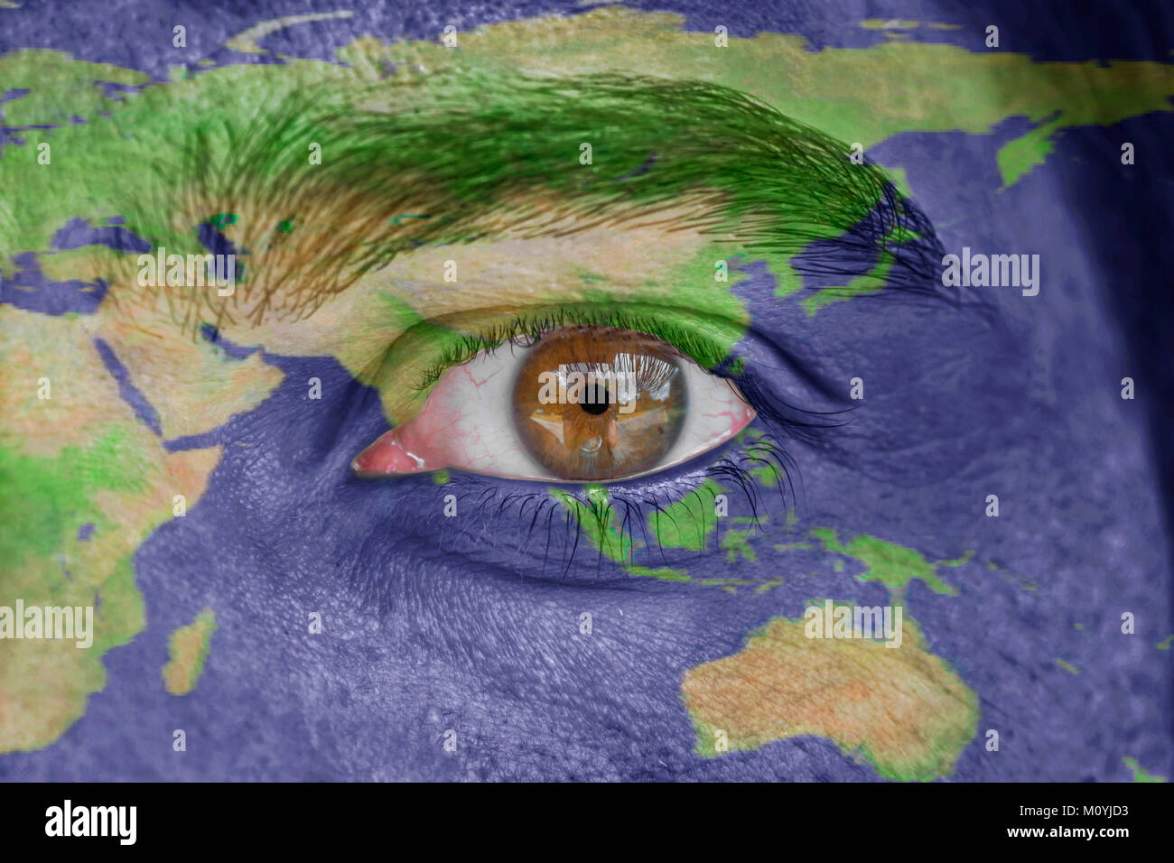 Human face and eye painted with Asia space geography map Stock Photo