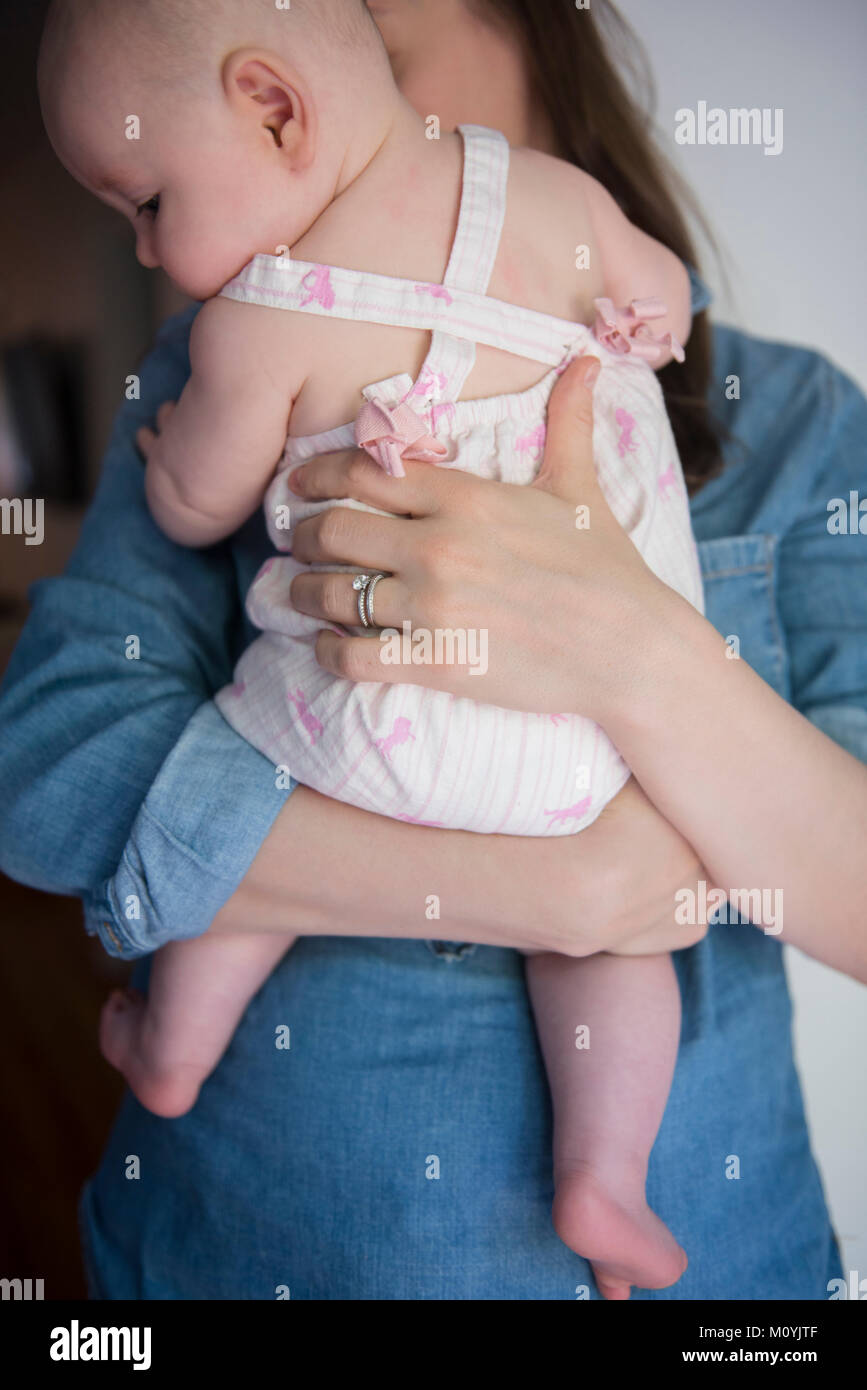 Caucasian mother holding baby daughter Stock Photo