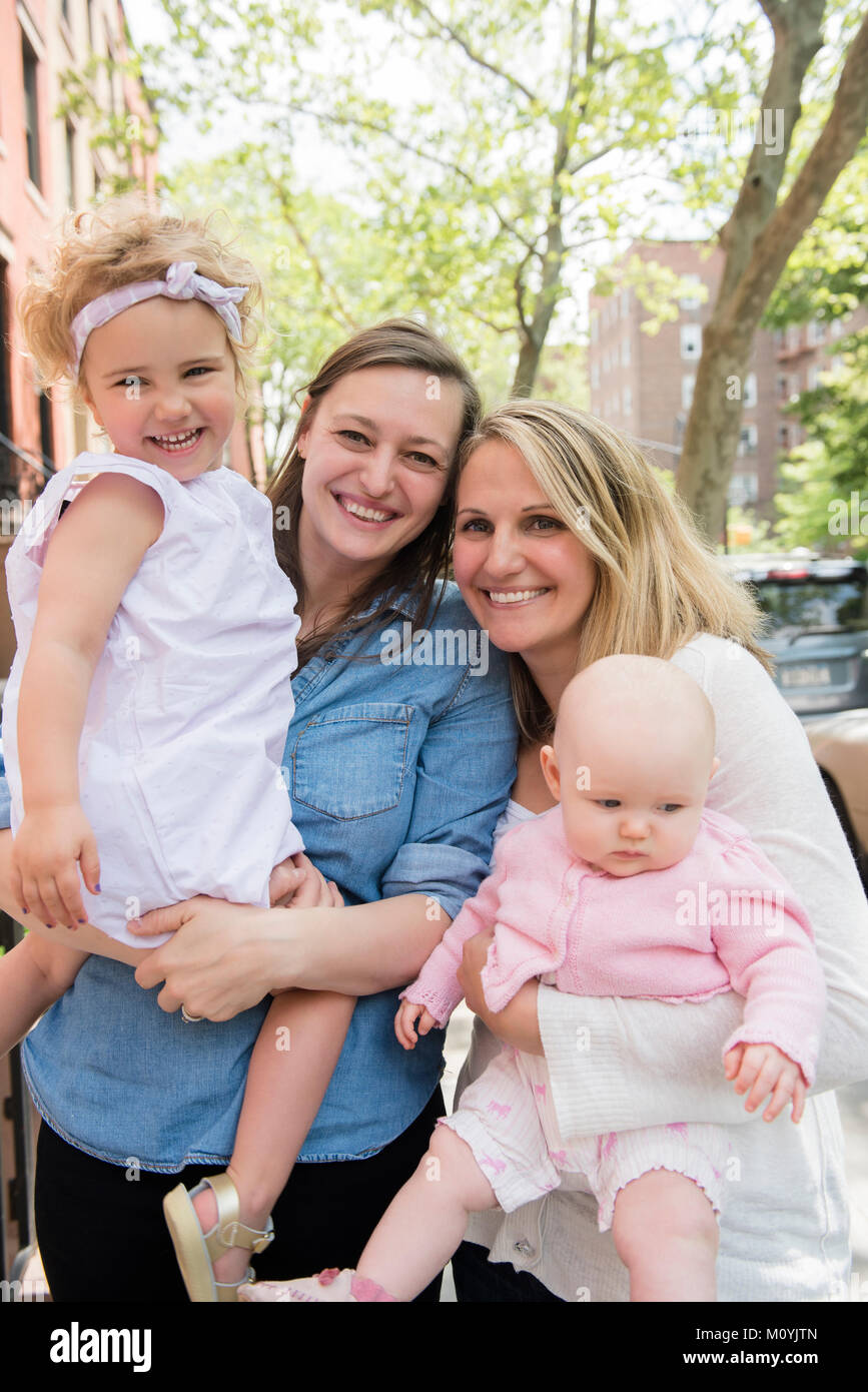 Portrait of Caucasian mothers and daughters in city Stock Photo