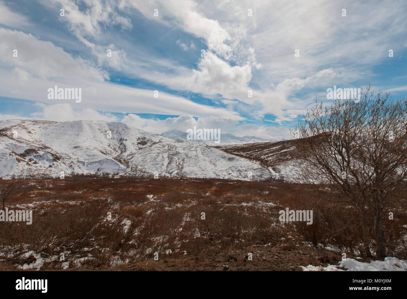Clouds over snow on mountain Stock Photo