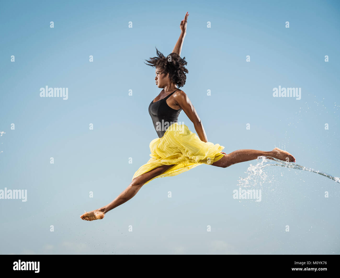 Water spraying on black woman ballet dancing Stock Photo