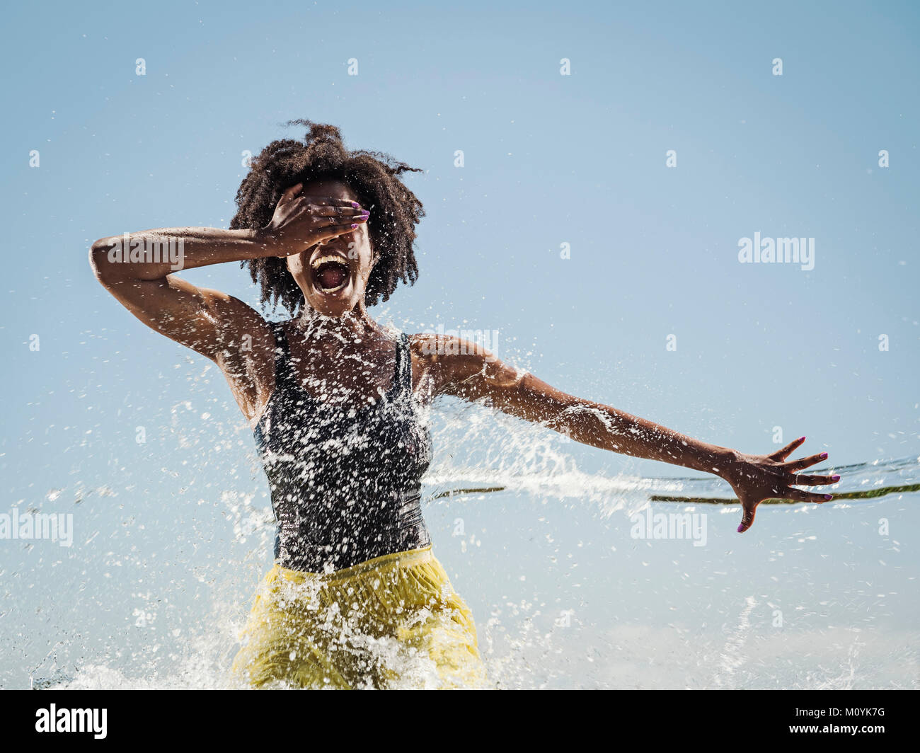 Water spraying on black woman dancing Stock Photo