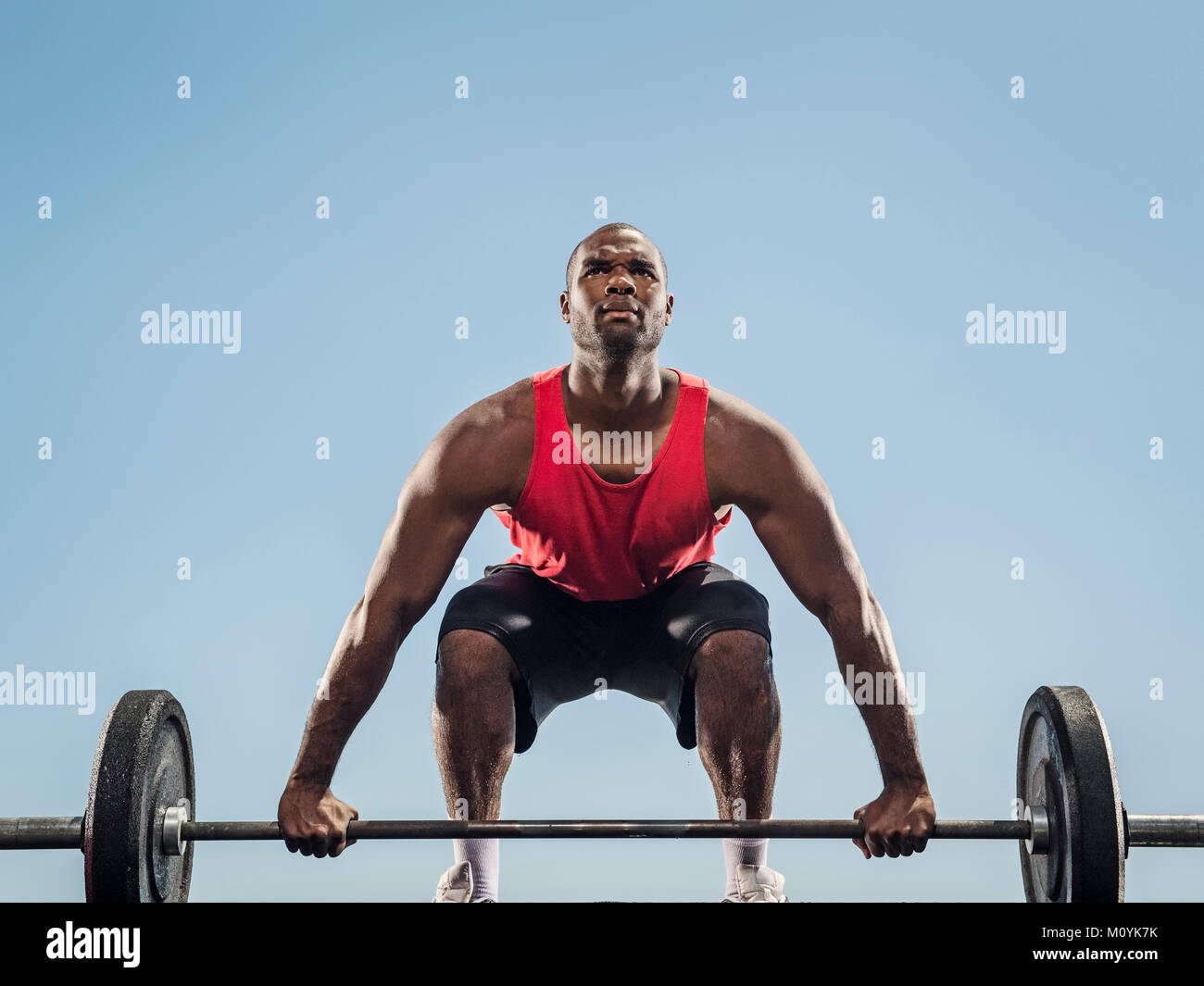 Black man preparing for lifting barbell Stock Photo