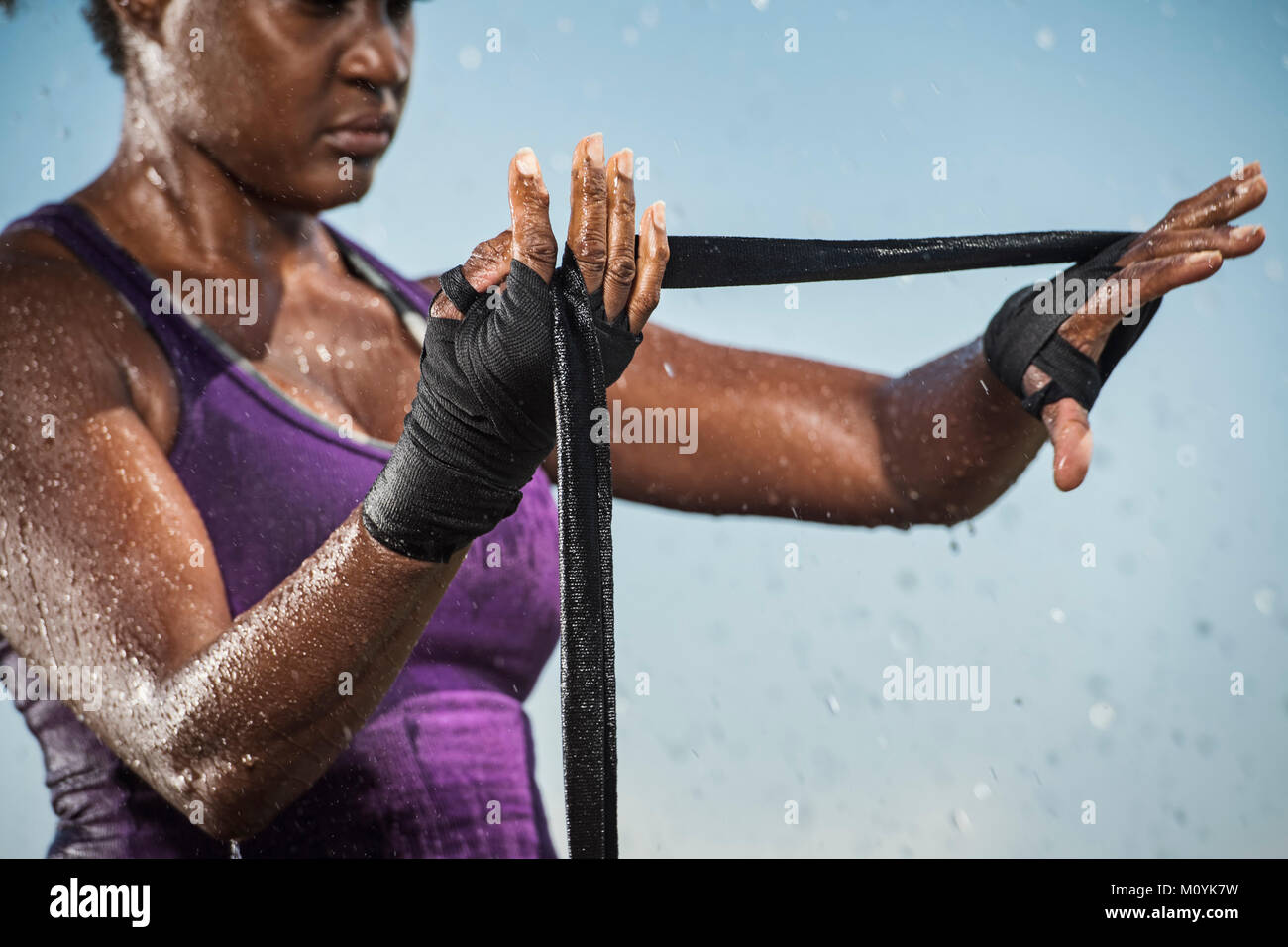 Black woman wrapping hands for boxing Stock Photo