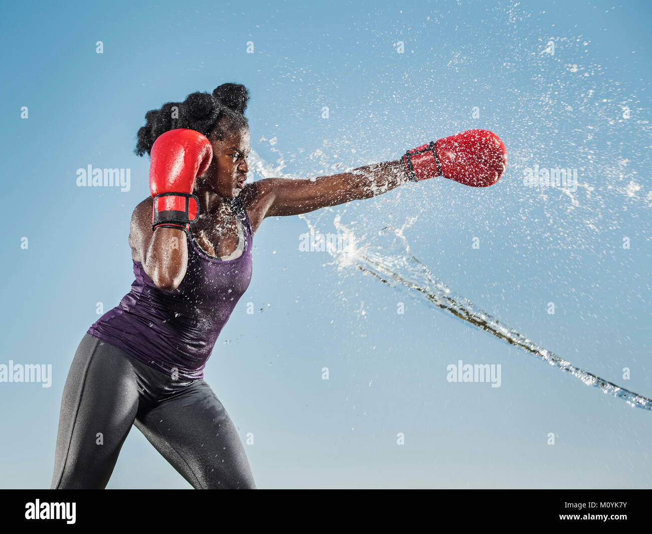 Water spraying on black woman boxing Stock Photo