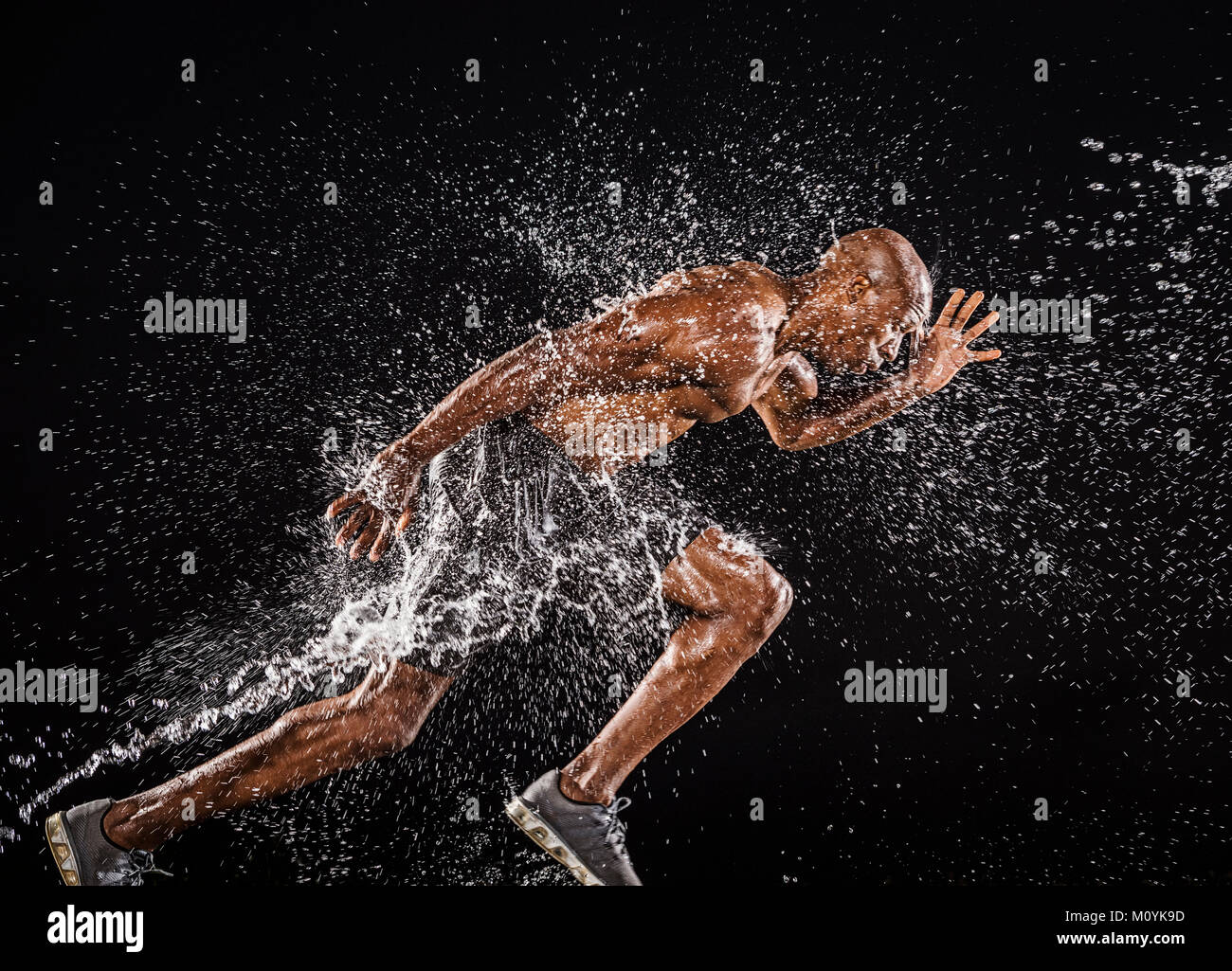 Water splashing on black runner Stock Photo