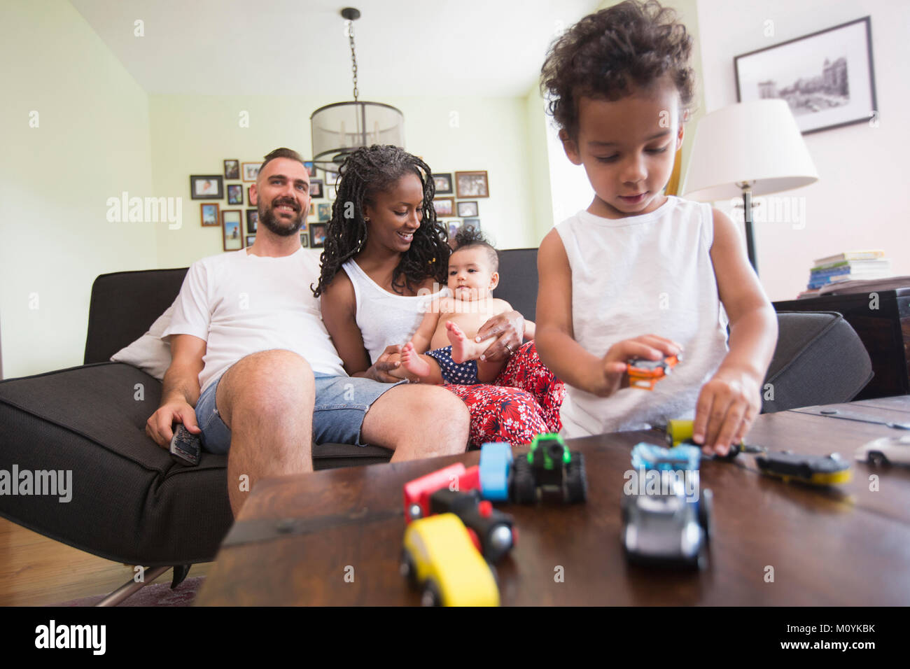 Family relaxing and playing in livingroom Stock Photo