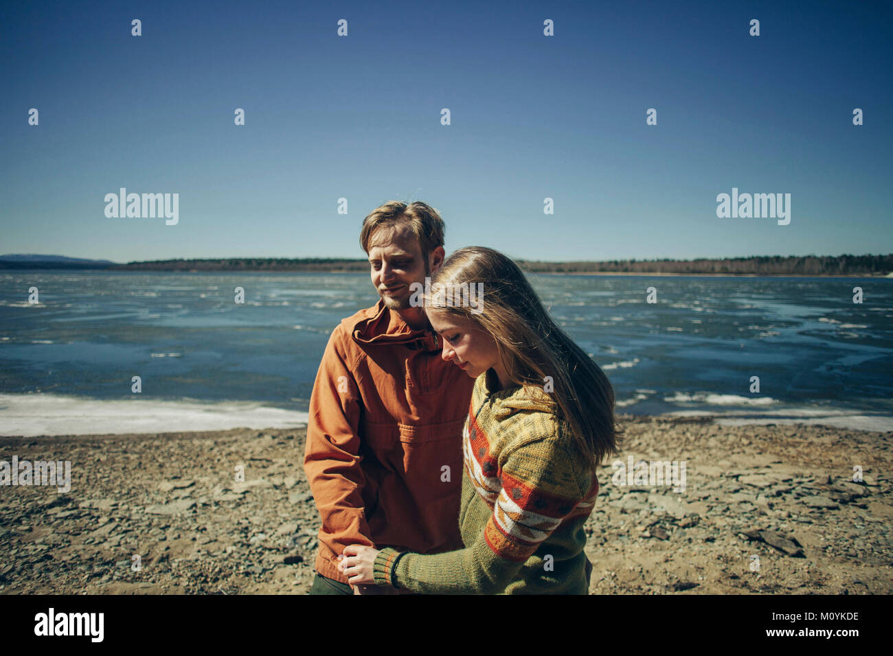 Caucasian couple holding hands on beach Stock Photo