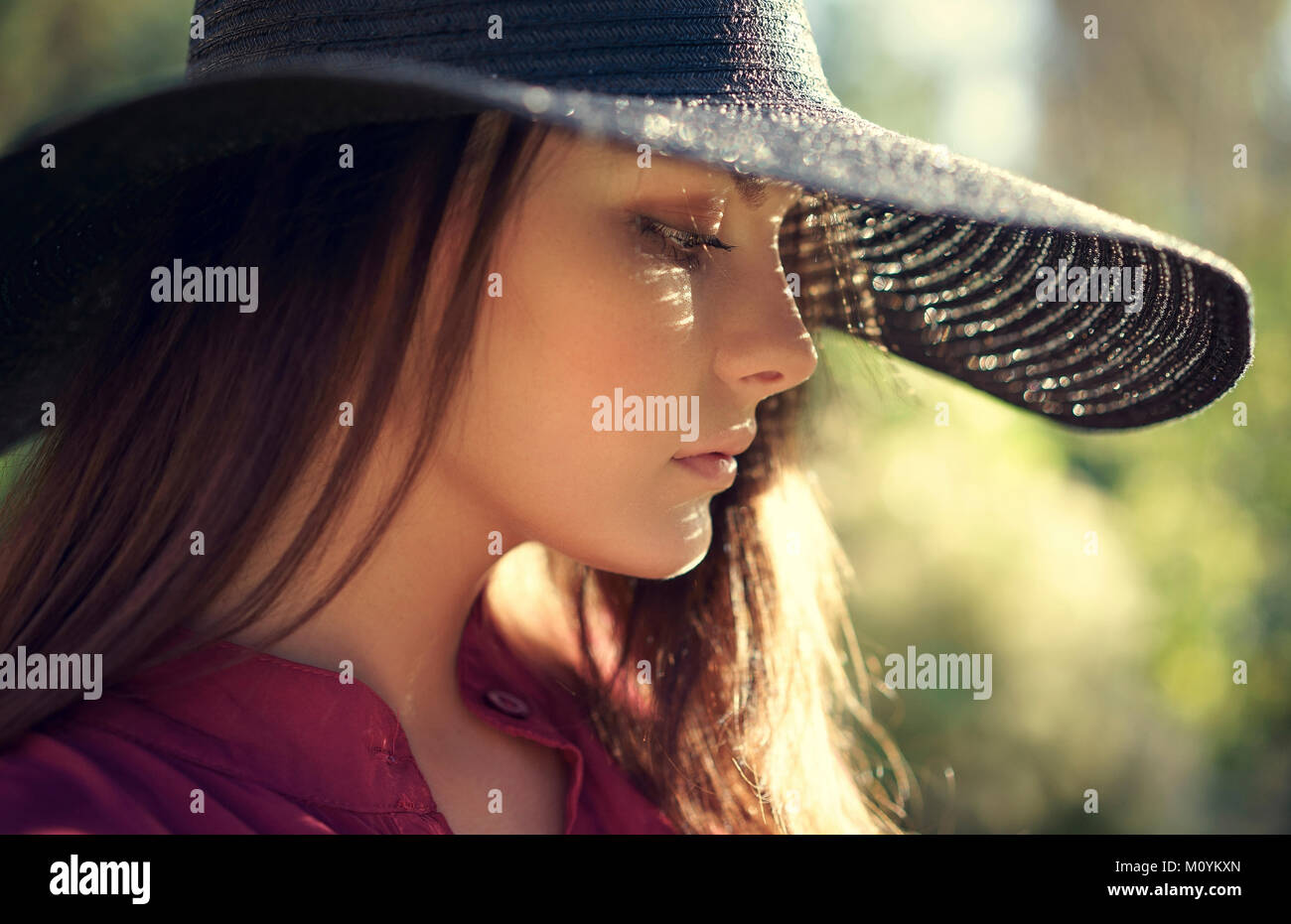 Close up of pensive Caucasian teenage girl wearing hat Stock Photo