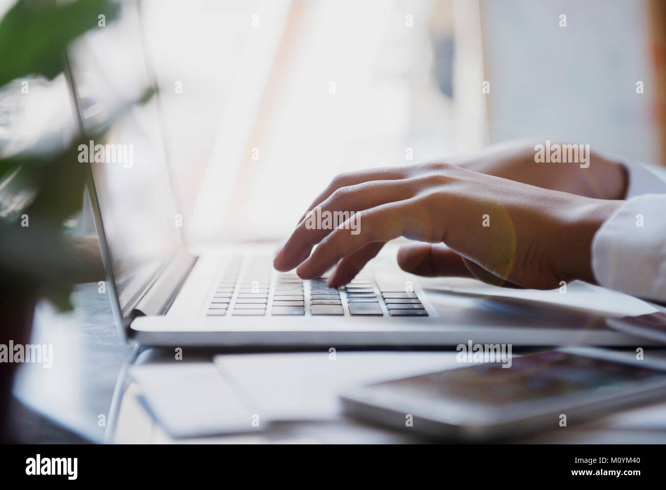 Hands of African American woman typing on laptop Stock Photo