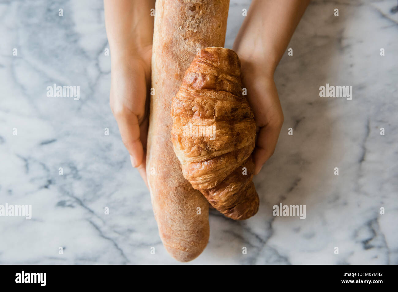 Hands of African American woman holding bread Stock Photo