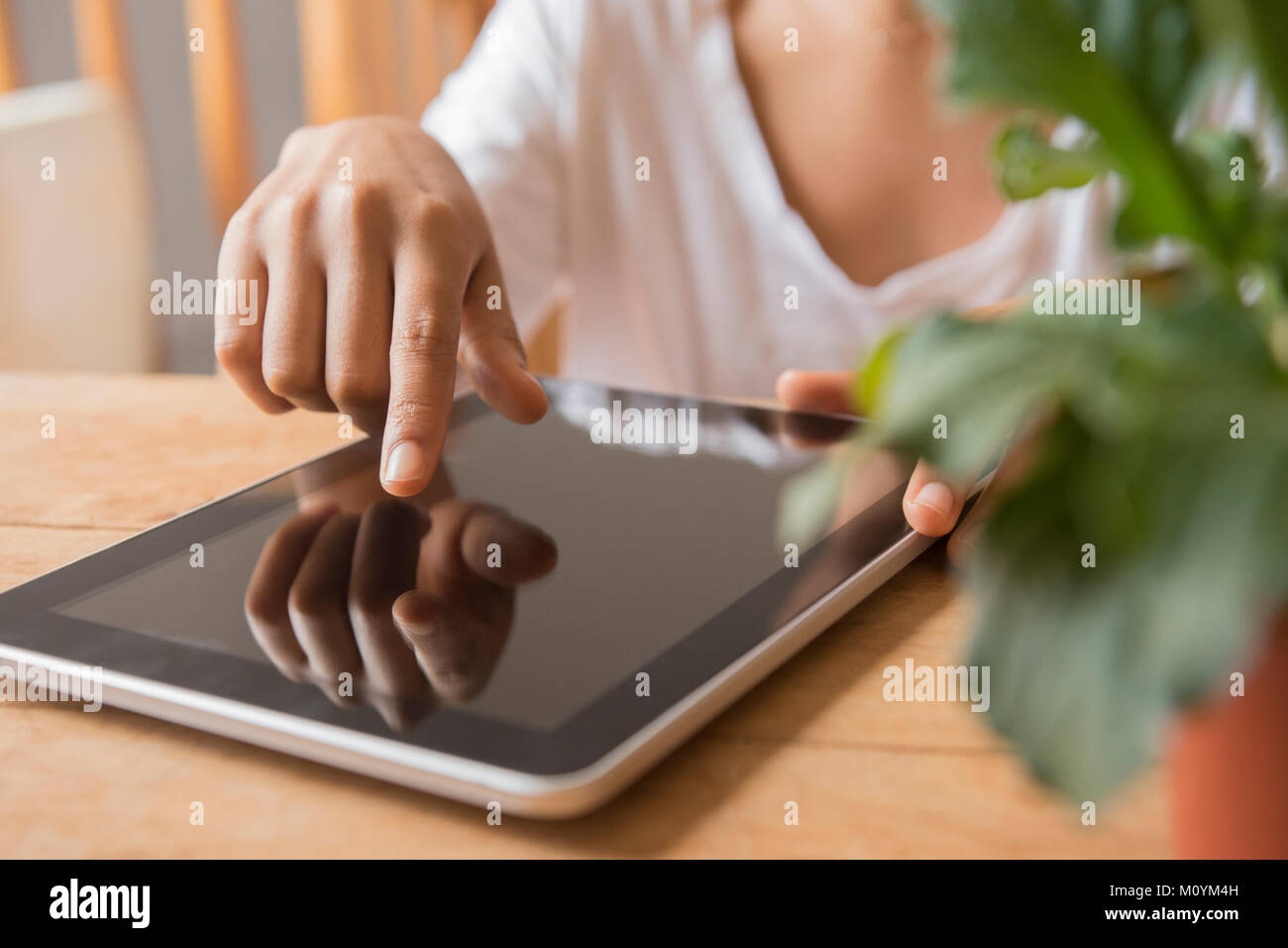 Hands of African American woman using digital tablet Stock Photo